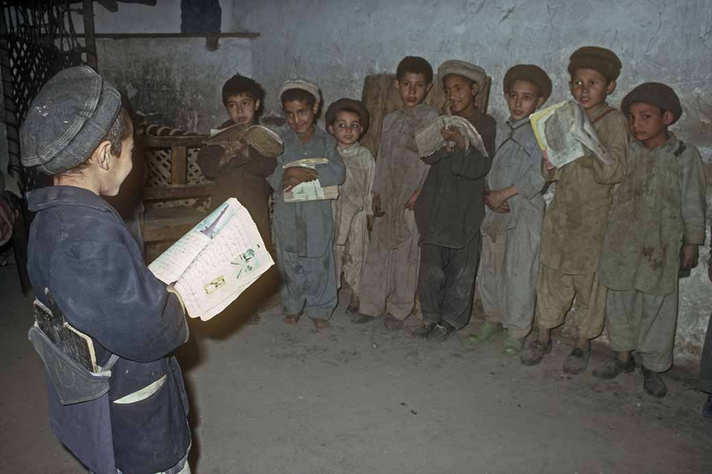 Boy reading to his classmates