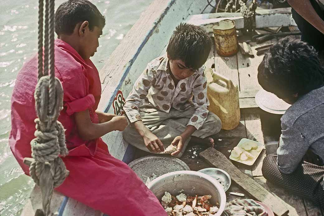 Boys eating crabs